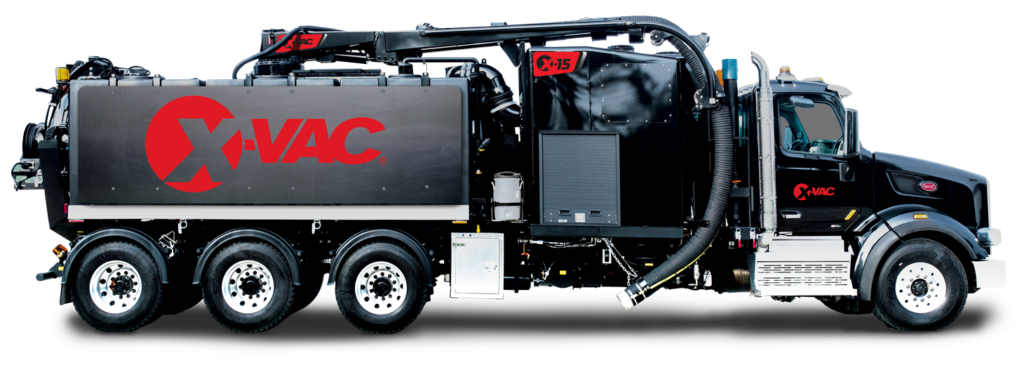 Black X‑Vac vacuum excavation truck with large tank, boom and suction hose, American-made hydro‑excavation equipment