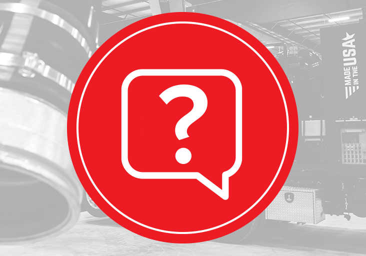 Red question-mark icon over grayscale X-Vac hydro excavation truck in shop, showing vacuum system and Made in the USA.